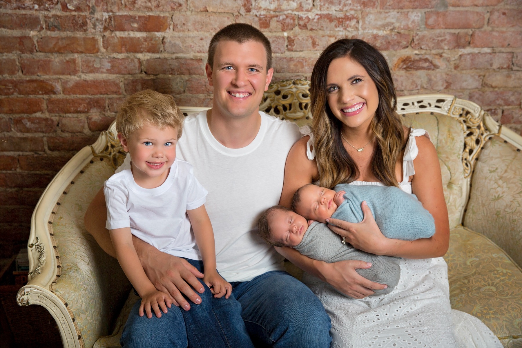 family of 5 on a couch with newborn twins