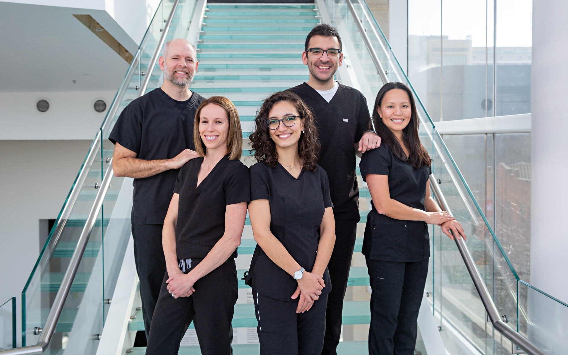 5 dentist pose in their black scrubs at the MMOCA from Madison Pediatric Dentistry