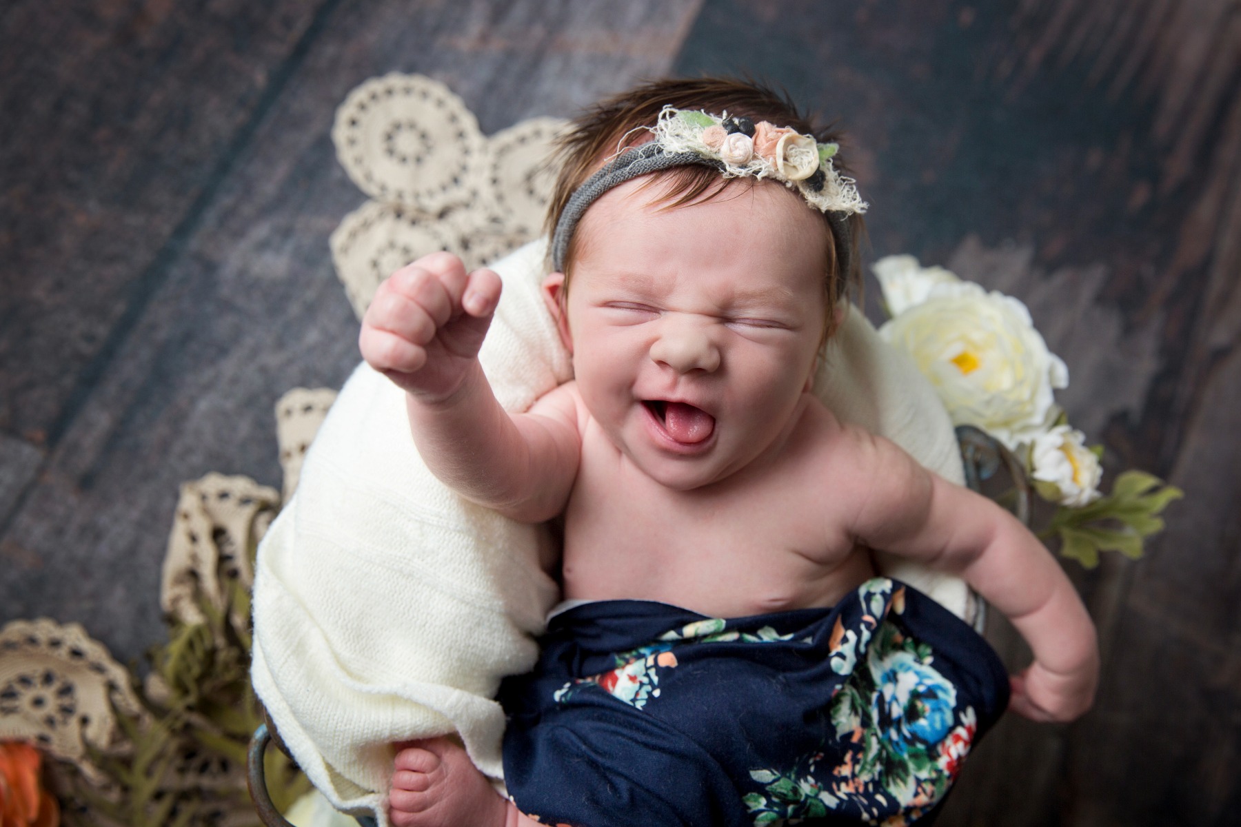 newborn baby appears to be cheering in her sleep