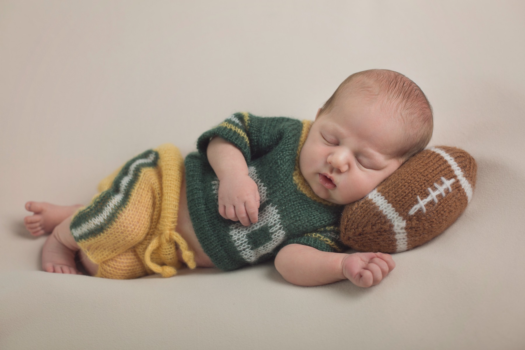 newborn boy in a Packers outfit